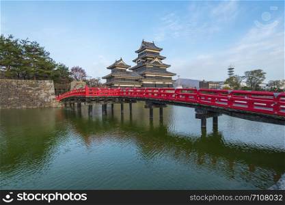 Matsumoto Castle with the red bridge in Nagano, Japan.