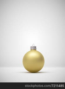 Matte gold crimson Christmas bauble centered on a light grey background for seasonal Holiday celebrations and themes