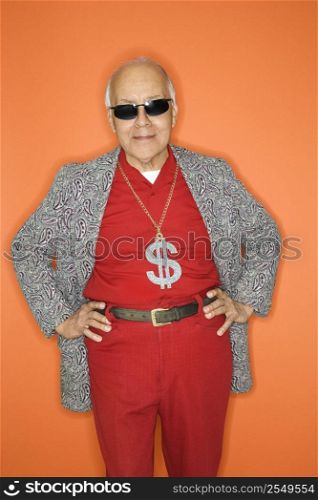 Mature adult Caucasian male wearing money sign necklace.