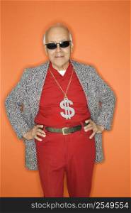 Mature adult Caucasian male wearing money sign necklace.
