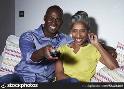 Mature African American Couple On Sofa Watching TV Together