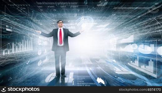 Mature and powerful. Confident businessman with hands spread apart on digital background