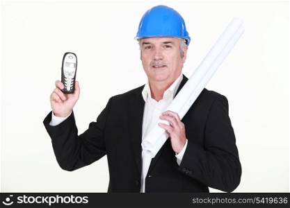 mature architect holding blueprints and phone