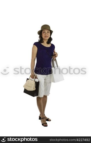 Mature Asian women holding shopping bags, sun glasses and purse on white background