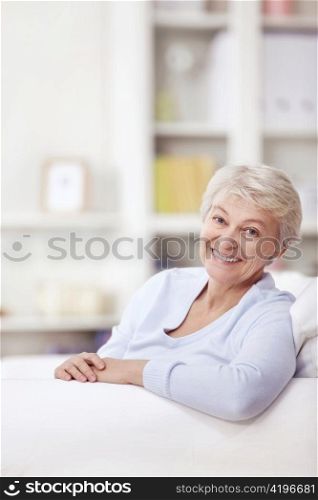 Mature attractive woman on the couch at home