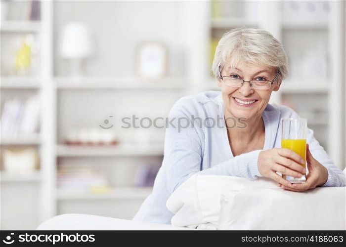 Mature attractive woman with a glass of juice