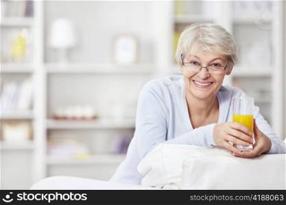 Mature attractive woman with a glass of juice