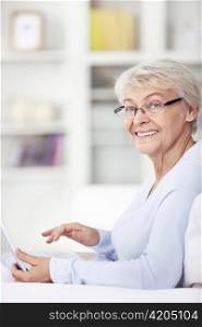 Mature attractive woman with a laptop at home