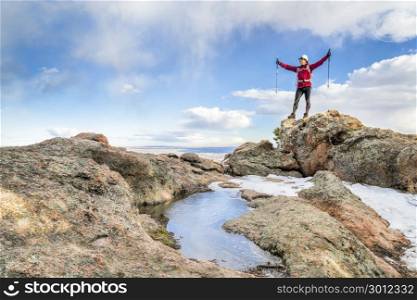 mature backpacker enjoying reaching a on a mountain top - Horsetooth Rock trail above Fort Collins in northern Colorado