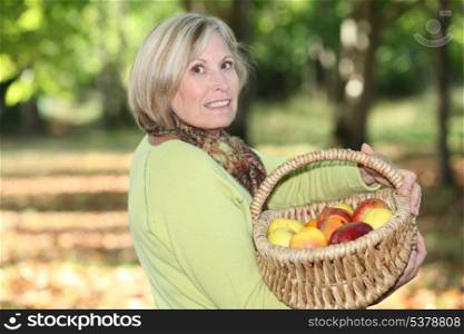 mature blonde woman in orchard