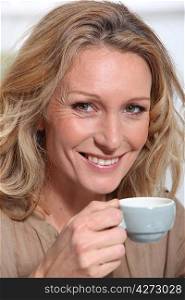 mature blonde woman with a cup of coffee