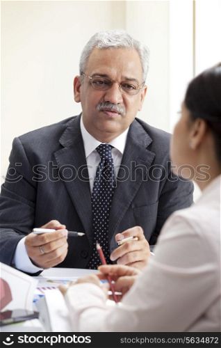 Mature business man discussing with female executive