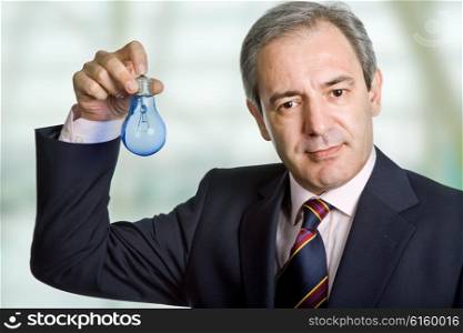 mature business man holding a blue lamp