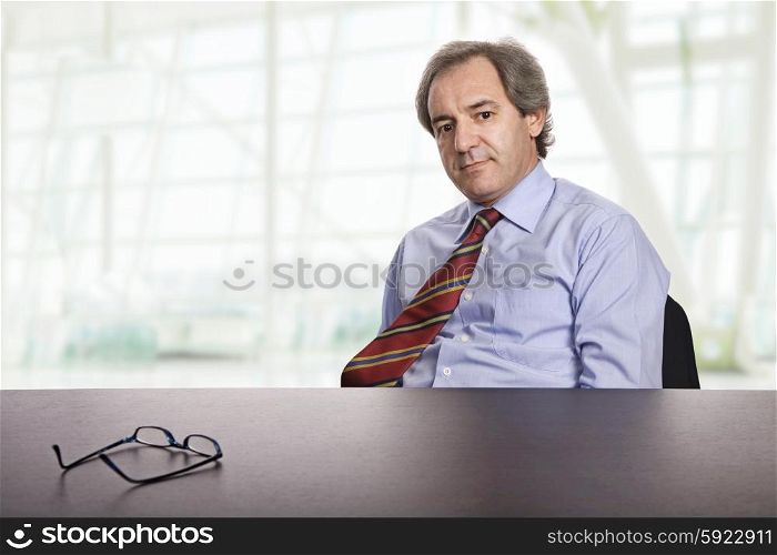 mature business man on a desk, at the office