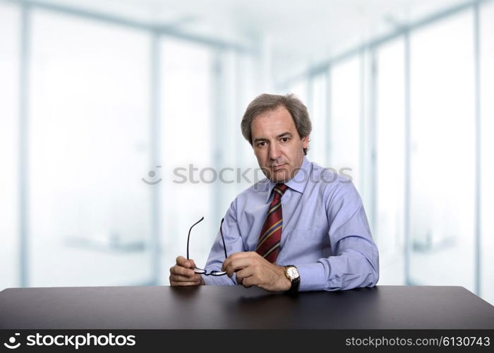 mature business man on a desk, at the office