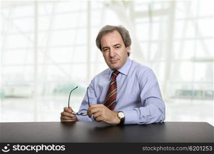 mature business man on a desk, at the office
