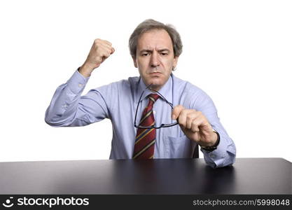 mature business man on a desk, isolated on white