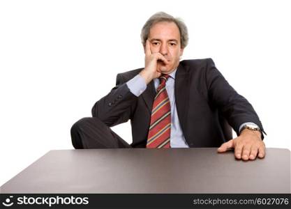 mature business man on a desk, isolated on white