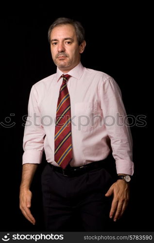 mature business man portrait on black background