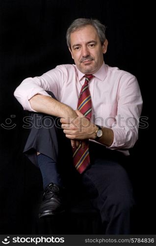 mature business man portrait on black background