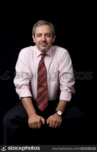 mature business man portrait on black background