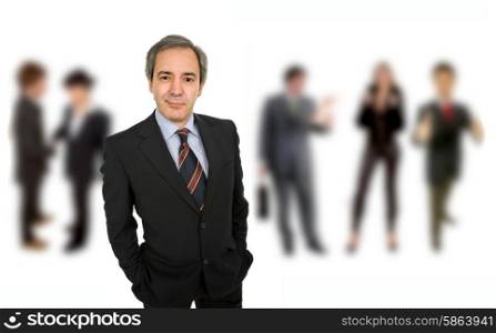 mature business man portrait with some people in the back