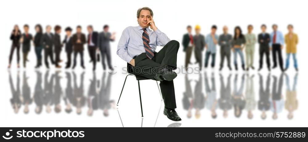 mature business man seated in front of a group of people