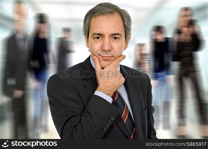 mature business man thinking among other people