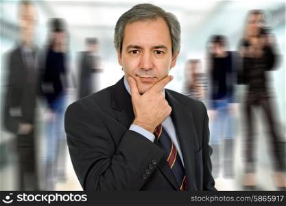 mature business man thinking among other people