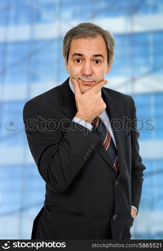 mature business man, thinking with his hand on the face