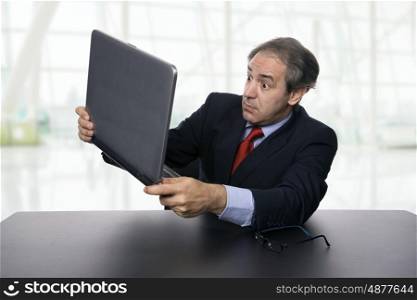 mature business man working with his laptop at the office