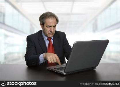 mature business man working with his laptop, at the office
