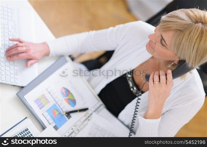Mature business woman making phone call. Top view