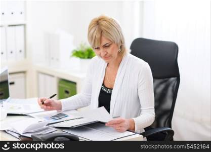 Mature business woman working at office