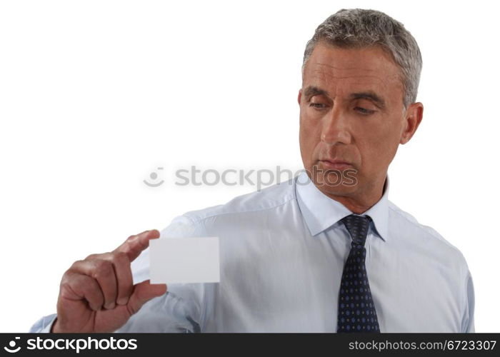 mature businessman holding business card