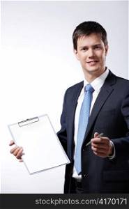 Mature businessman holds out the clipboard and a pen