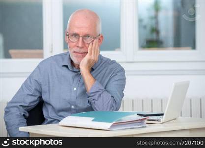 mature businessman in blue shirt in his office