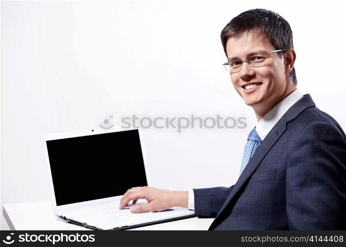 Mature businessman in glasses with a laptop