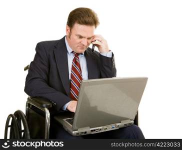 Mature businessman in wheelchair using his laptop and talking on the phone. Isolated on white.