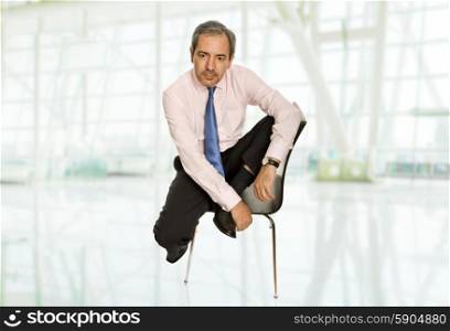 mature businessman on a chair at the office