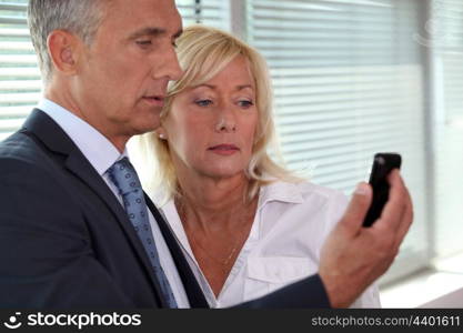 mature businessman showing his blonde wife sms