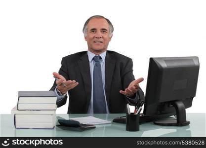 mature businessman sitting at his desk