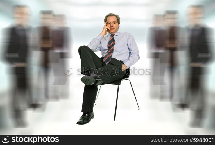 mature businessman thinking, seated on a chair