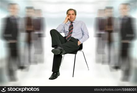 mature businessman thinking, seated on a chair