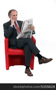 Mature businessman with a newspaper