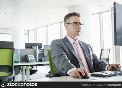 Mature businessman working on computer in office