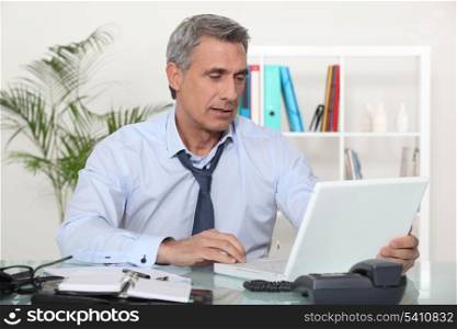 mature businessman working on his desk
