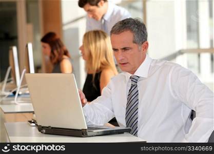 Mature businessman working on laptop computer