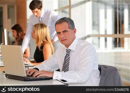 Mature businessman working on laptop computer