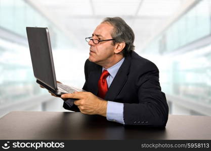 mature businessman working with his laptop at the office